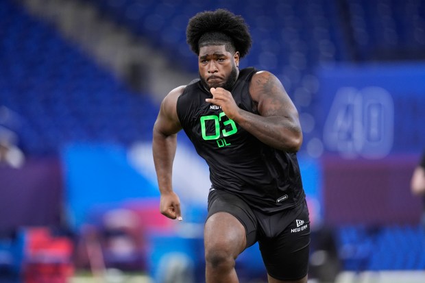 Alabama offensive lineman Tyler Booker runs a drill at the NFL combine in Indianapolis on March 2, 2025. (AP Photo/George Walker IV)