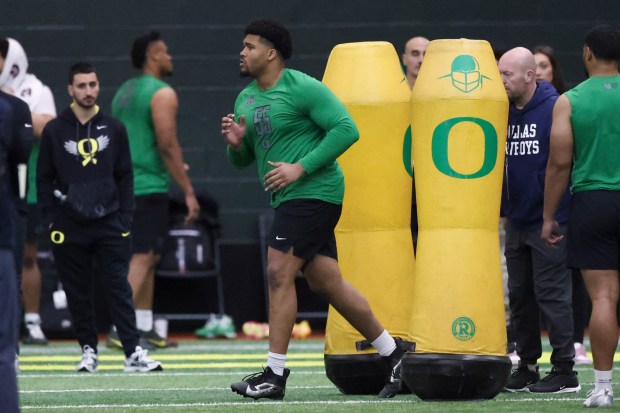 Oregon defensive lineman Derrick Harmon runs a position drill at the school's NFL pro day March 18, 2025, in Eugene, Ore. (AP Photo/Amanda Loman)
