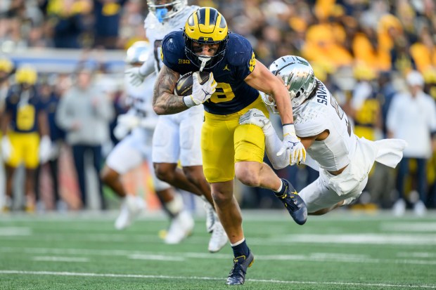 Michigan tight end Colston Loveland is tackled by Oregon defensive back Kobe Savage on Nov. 2, 2024, in Ann Arbor, Mich. (David Guralnick/The Detroit News)