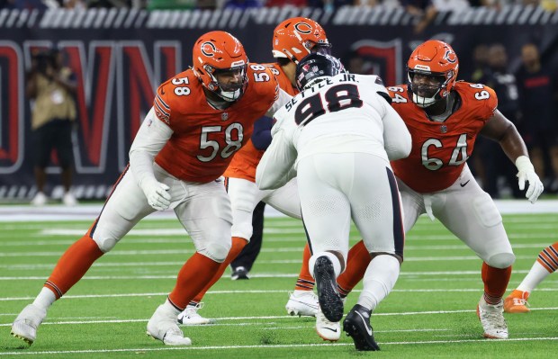 Bears offensive tackle Darnell Wright (58) and guard Nate Davis (64) work to protect quarterback Caleb Williams against the Texans on Sept. 15, 2024, at NRG Stadium in Houston. (John J. Kim/Chicago Tribune)