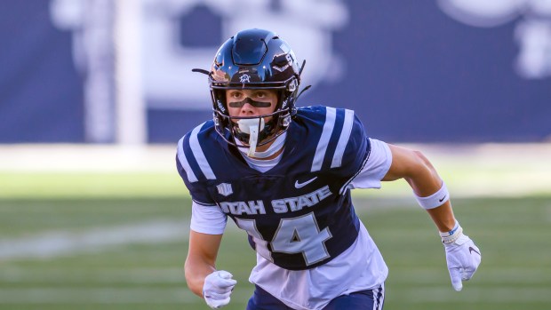 Utah State wide receiver Jack Hestera (14) runs off the line of scrimmage during an NCAA football game on Saturday, Sept. 14, 2024 in Logan, Utah. (AP Photo/Tyler Tate)