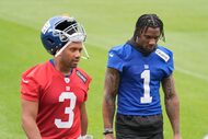 New York Giants' Malik Nabers, right, talks with quarterback Russell Wilson as they walk off...