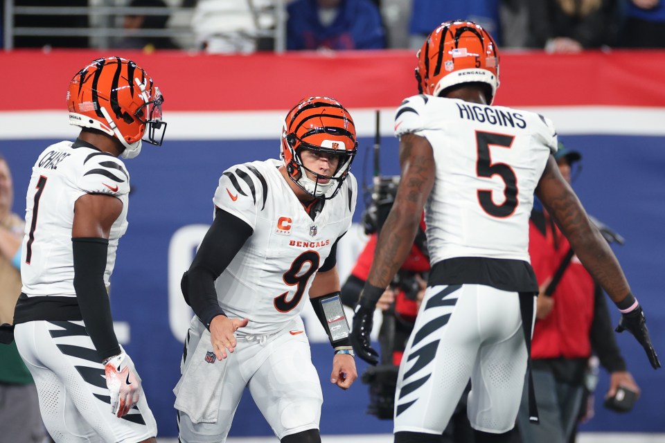 EAST RUTHERFORD, NEW JERSEY - OCTOBER 13: Joe Burrow #9 of the Cincinnati Bengals celebrates a touchdown with Ja'Marr Chase #1 and Tee Higgins #5 during the first half against the New York Giants at MetLife Stadium on October 13, 2024 in East Rutherford, New Jersey. (Photo by Sarah Stier/Getty Images)