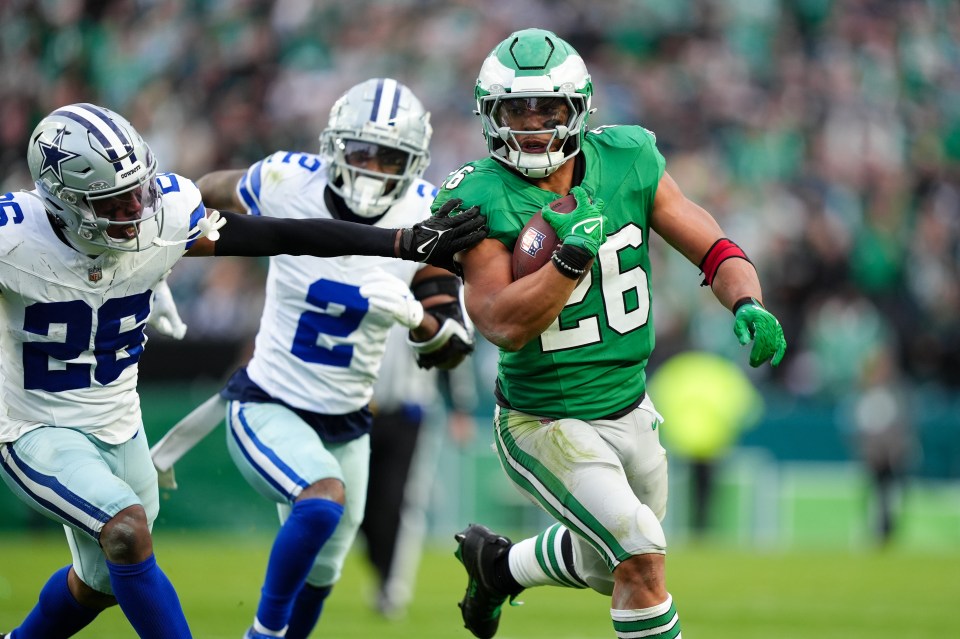 PHILADELPHIA, PA - DECEMBER 29: Philadelphia Eagles running back Saquon Barkley (26) carries the ball against Dallas Cowboys defensive back DaRon Bland (26) in the second half during the game between the Dallas Cowboys and Philadelphia Eagles on December 29, 2024 at Lincoln Financial Field in Philadelphia, PA. (Photo by Kyle Ross/Icon Sportswire via Getty Images)