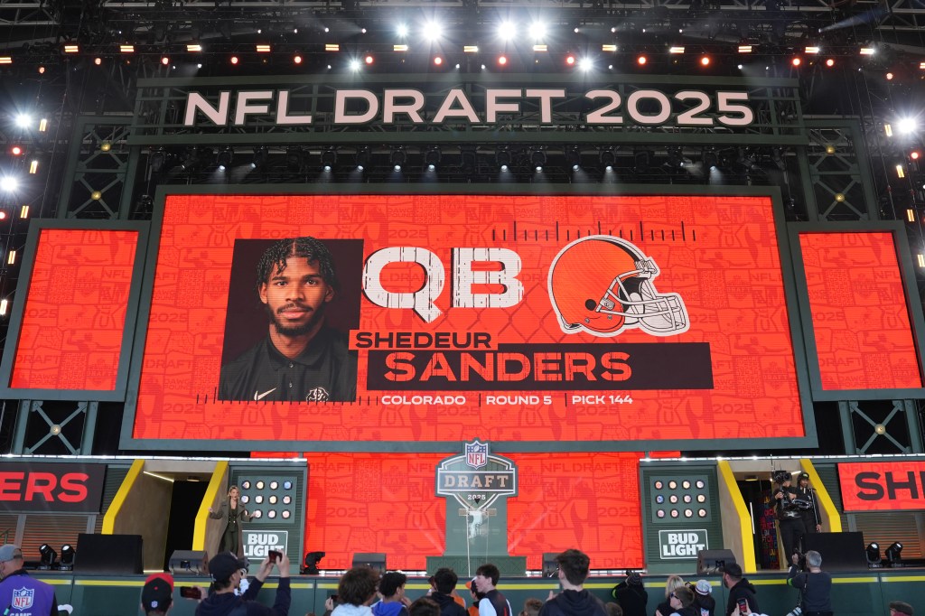 A screen shows Colorado quarterback Shedeur Sanders' name after being selected by the Cleveland Browns with the 144th overall pick during the fifth round of the 2025 NFL Draft on April 26, 2025 in Green Bay, Wisconsin. 