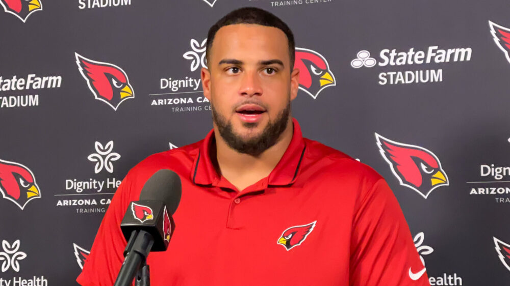 Arizona Cardinals guard Isaiah Adams speaks with reporters...