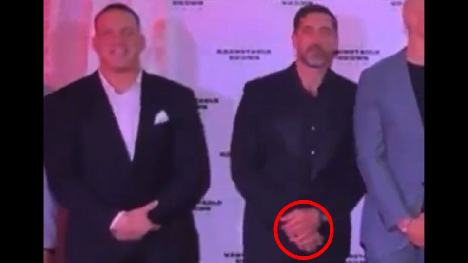 Two men in suits standing side-by-side.