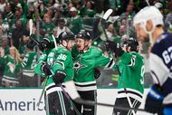 Dallas Stars center Roope Hintz (24) celebrates a goal with right wing Mikko Rantanen (96),...