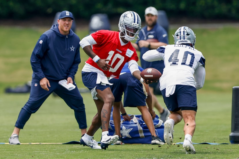 Dallas Cowboys quarterback Joe Milton III (10) hands the ball to running back Hunter Luepke...