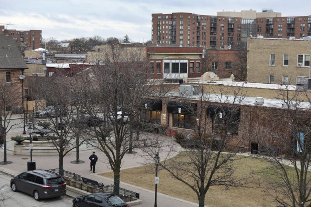 A person crosses through Harmony Park at Campbell Street and...