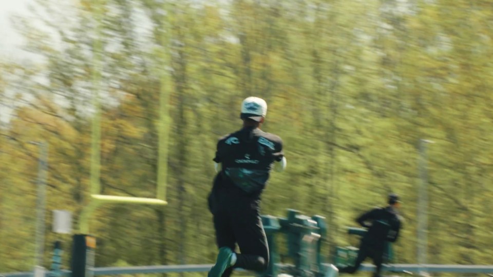Blurry photo of a person running on a field towards a goalpost.