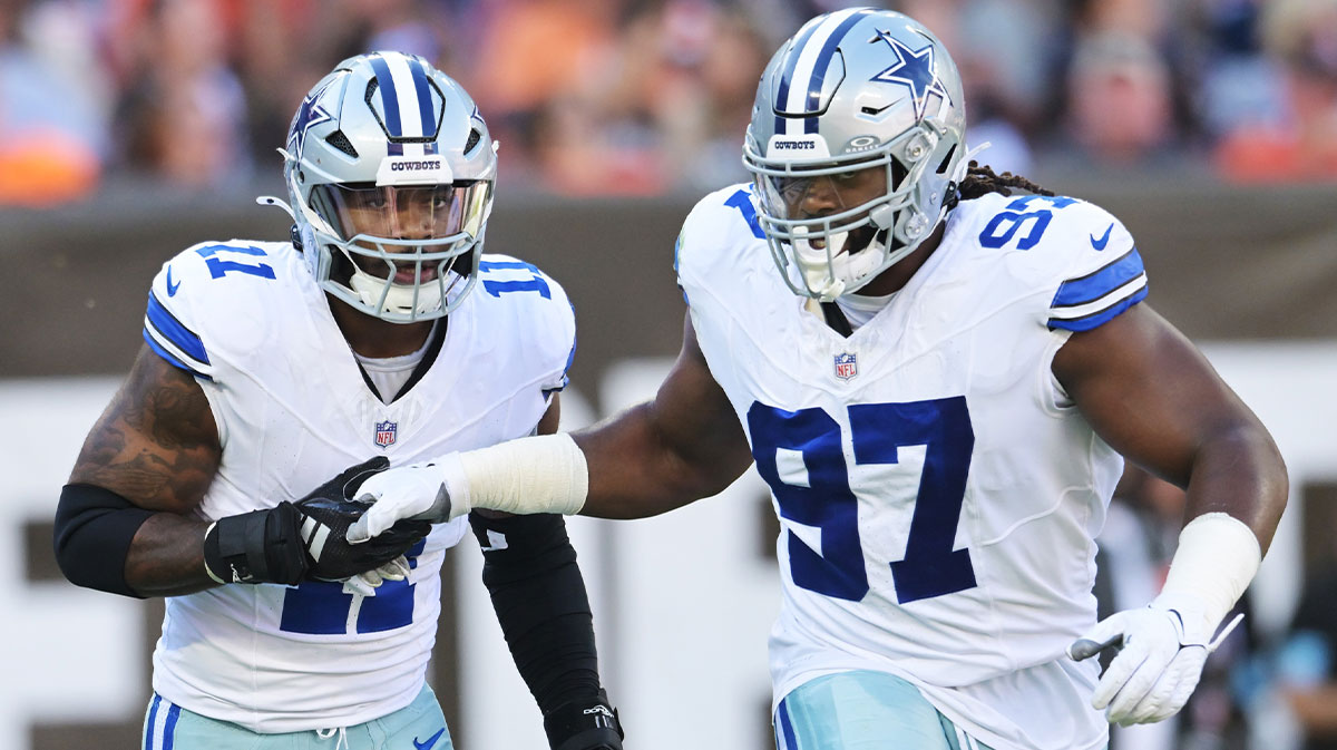 Dallas Cowboys linebacker Micah Parsons (11) celebrates with defensive tackle Osa Odighizuwa (97) after a sack during the first quarter against the Cleveland Browns at Huntington Bank Field.