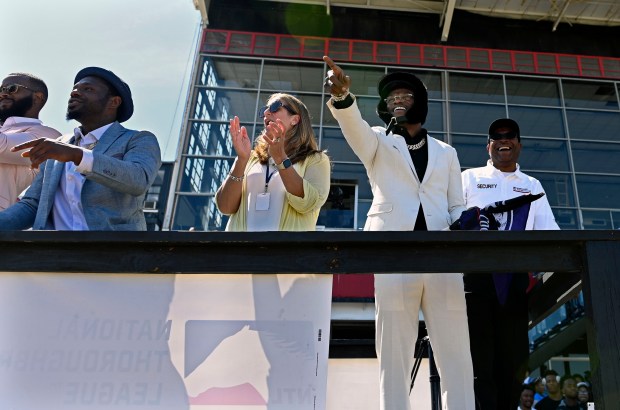 Quarterback Lamar Jackson, second right, laughs as he watches a...