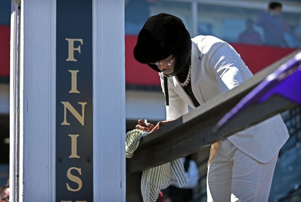Ravens quarterback Lamar Jackson signs autographs for fans during the...