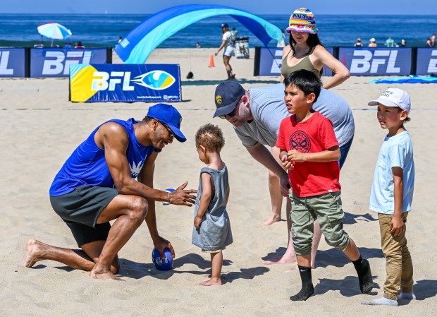 Los Angeles Rams safety Quentin Lake helps lead kids through...