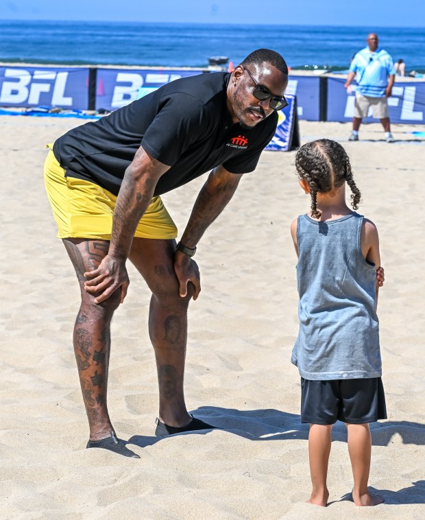 Super Bowl winner Malik Jackson helps lead kids through drills...