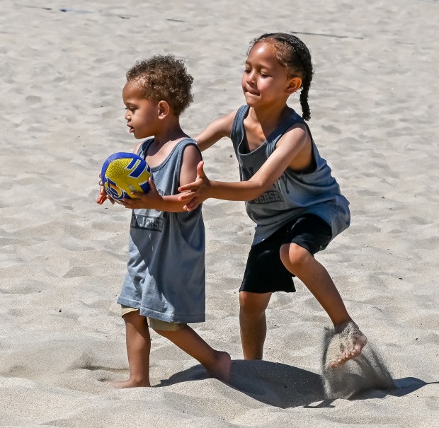 Kids participate in tryouts and warm-ups at the Beach Football...