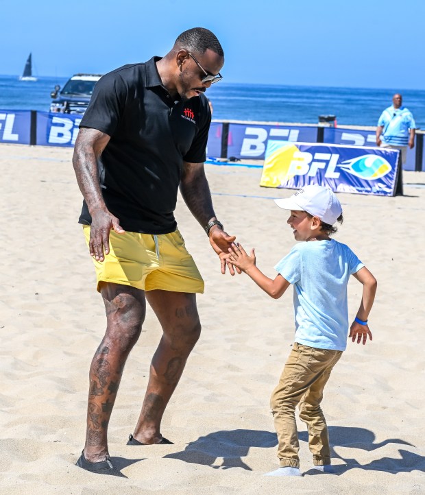 Super Bowl winner Malik Jackson helps lead kids through drills...