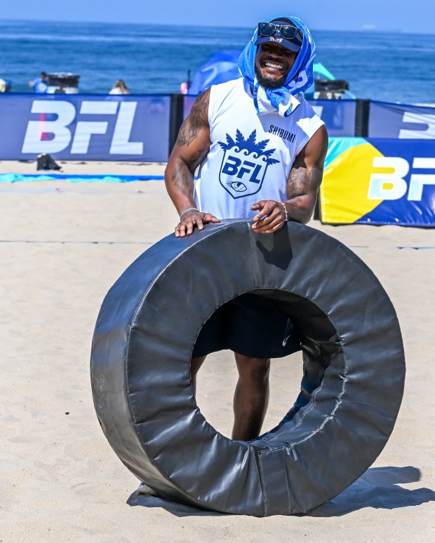 Los Angeles Chargers linebacker Denzel Perryman helps lead kids through...