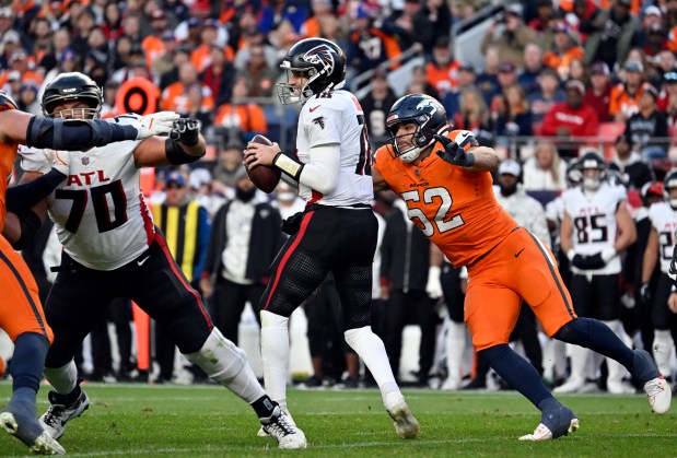 Jonah Elliss (52) of the Denver Broncos comes in for a sack on Kirk Cousins (18) of the Atlanta Falcons during the third quarter at Empower Field at Mile High in Denver on Sunday, Nov. 17, 2024. (Photo by Eric Lutzens/The Denver Post)