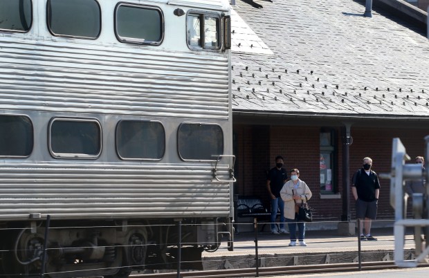 A Metra train arrives as the station in Arlington Heights...
