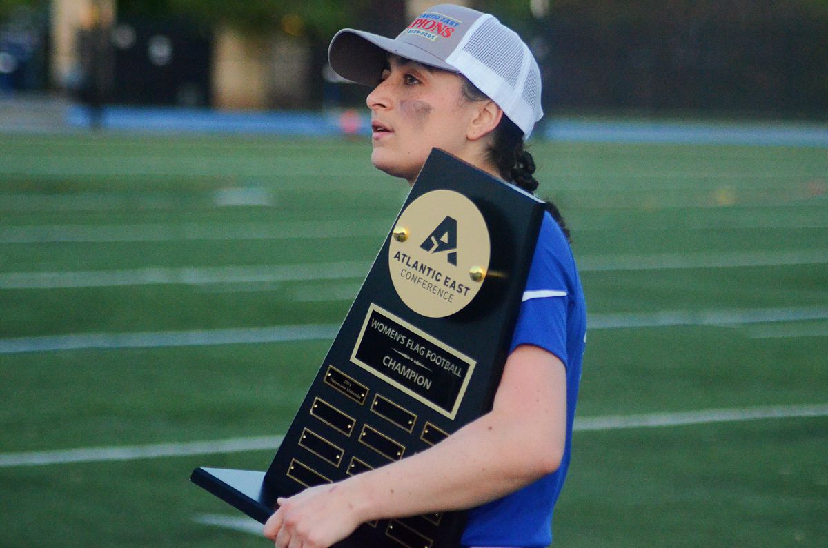 Marymount’s Carly Rivera holds the trophy after winning the Atlantic East Championship for women’s flag football on Saturday, April 26, 2025, in Arlington, Va.