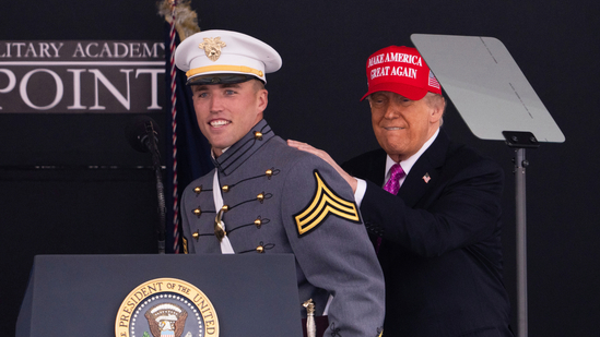 President Donald Trump pats graduating cadet Bryson Daily on the back, who is an American college football quarterback for the Army Black Knights, during the United States Military Academy commencement ceremonies in West Point, N.Y., Saturday, May 24, 2025. (AP Photo/Adam Gray)(AP)