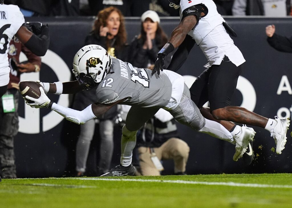 Colorado Buffaloes wide receiver Travis Hunter dives for a touchdown in the second quarter against the Cincinnati Bearcats in college football game action at Folsom Field