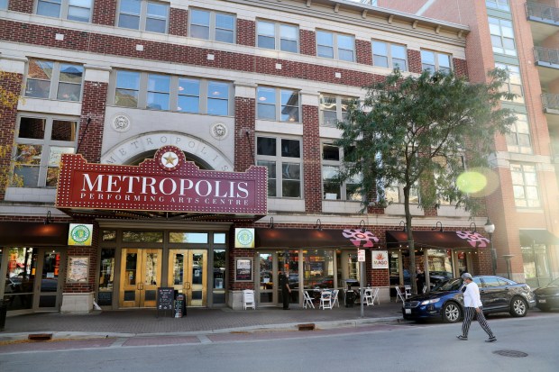A person crosses the street in front of Metropolis Performing...