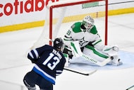 Dallas Stars goaltender Jake Oettinger (29) makes a save on Winnipeg Jets' Gabriel Vilardi...