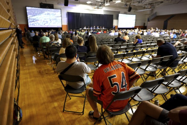 Audience members listen as representatives from the Bears present their...