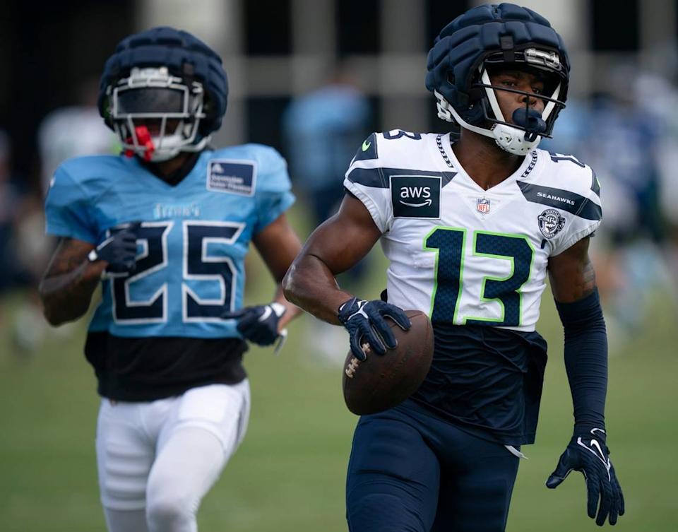 Seattle Seahawks wide receiver Easop Winston Jr. (13), from Washington State University, runs with his catch after beating Tennessee Titans running back Hassan Haskins (25) on the play. It was the first of two joint NFL practices at the Saint Thomas Sports Park in Nashville, Tenn., Wednesday, Aug. 14 2024. Denny Simmons / The Tennessean via USA Today Network/USA TODAY NETWORK