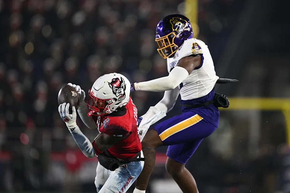 Dec 28, 2024; Annapolis, MD, USA; North Carolina State Wolfpack cornerback Tamarcus Cooley (15) intercepts a pass during the second half of the Go Bowling Military Bowl against the East Carolina Pirates at Navy-Marine Corps Memorial Stadium. Mandatory Credit: Tommy Gilligan-Imagn Images