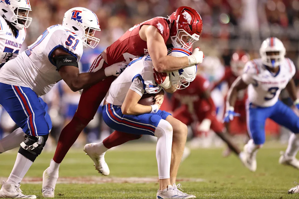 Nov 23, 2024; Fayetteville, Arkansas, USA; Arkansas Razorbacks defensive lineman Landon Jackson (40) sacks Louisiana Tech Bulldogs quarterback Evan Bullock (7) during the fourth quarter at Donald W. Reynolds Razorback Stadium. Arkansas won 35-14. Mandatory Credit: Nelson Chenault-Imagn Images