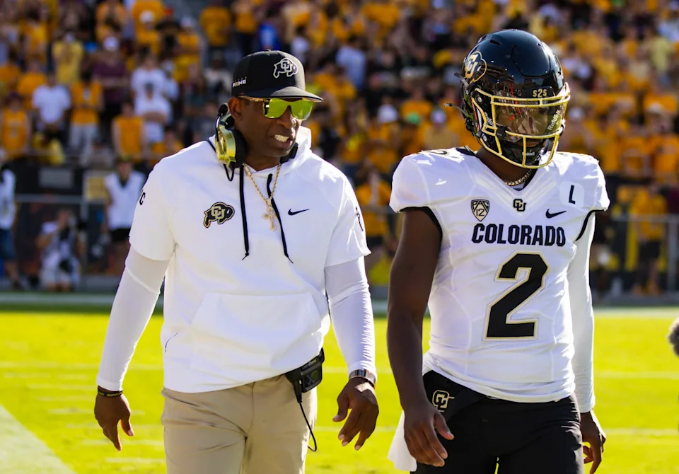 Colorado Buffaloes head coach Deion Sanders (Left) and quarterback Shedeur Sanders (Right)© Mark J. Rebilas-Imagn Images