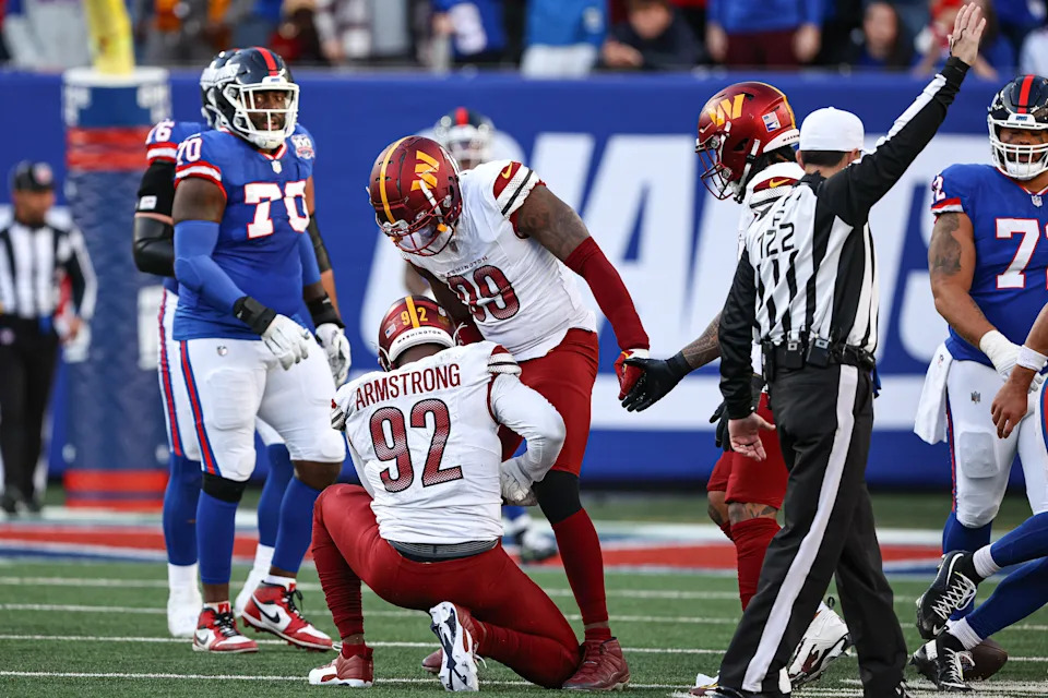 Nov 3, 2024; East Rutherford, New Jersey, USA; Washington Commanders defensive end Dorance Armstrong (92) celebrates his sack on New York Giants quarterback Daniel Jones (not pictured) with defensive end Clelin Ferrell (99) during the second half at MetLife Stadium. Mandatory Credit: Vincent Carchietta-Imagn Images