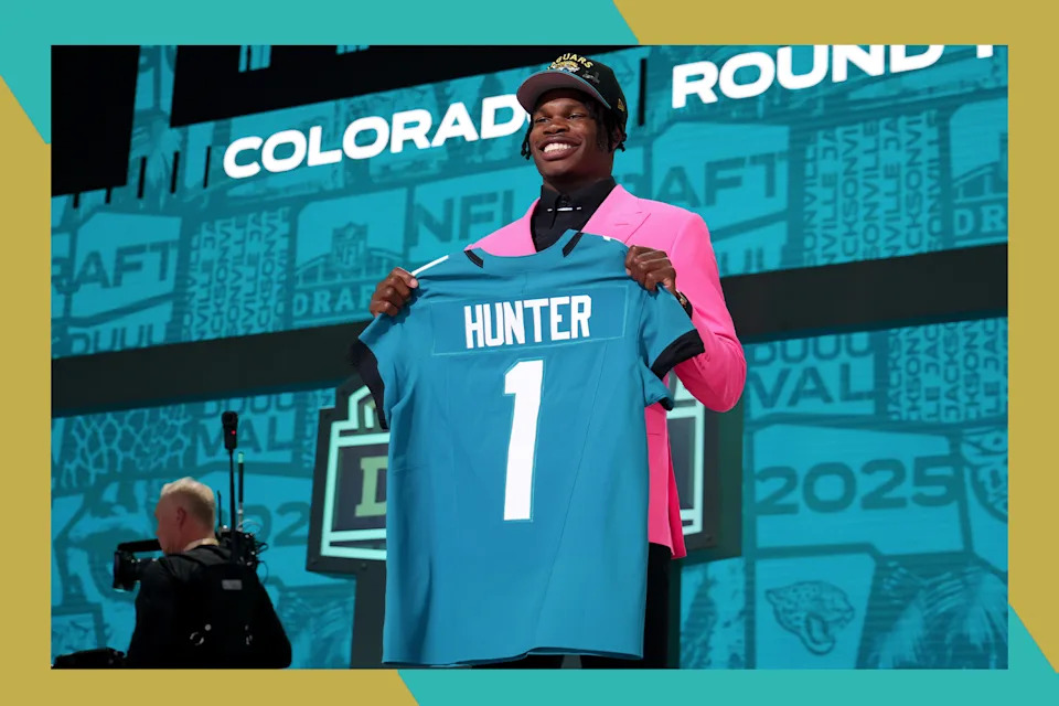 Jacksonville Jaguars star Travis Hunter smiles with his new jersey at the NFL Draft.