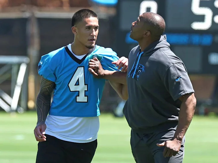 Carolina Panthers rookie wide receiver Tetairoa McMillan, left, receives technique help from wide receivers coach Rob Moore, left, during the team’s rookie minicamp practice on Friday, May 9, 2025. JEFF SINER/jsiner@charlotteobserver.com