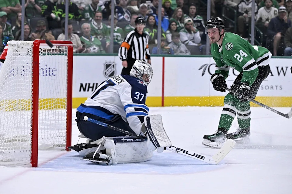 Dallas Stars center Roope Hintz (24) watches as the puck hits the crossbar behind Winnipeg Jets goaltender Connor Hellebuyck (37) during the second period at the American Airlines Center.Jerome Miron-Imagn Images