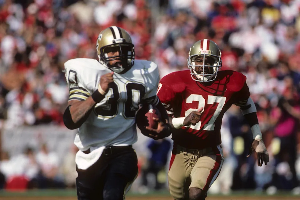 SAN FRANCISCO - SEPTEMBER 29: Running back Wayne Wilson #30 of the New Orleans Saints runs away from defensive back Carlton Williamson #27 of the San Francisco 49ers during a game at Candlestick Park on September 29, 1985 in San Francisco, California. The Saints won 20-17. (Photo by George Rose/Getty Images)