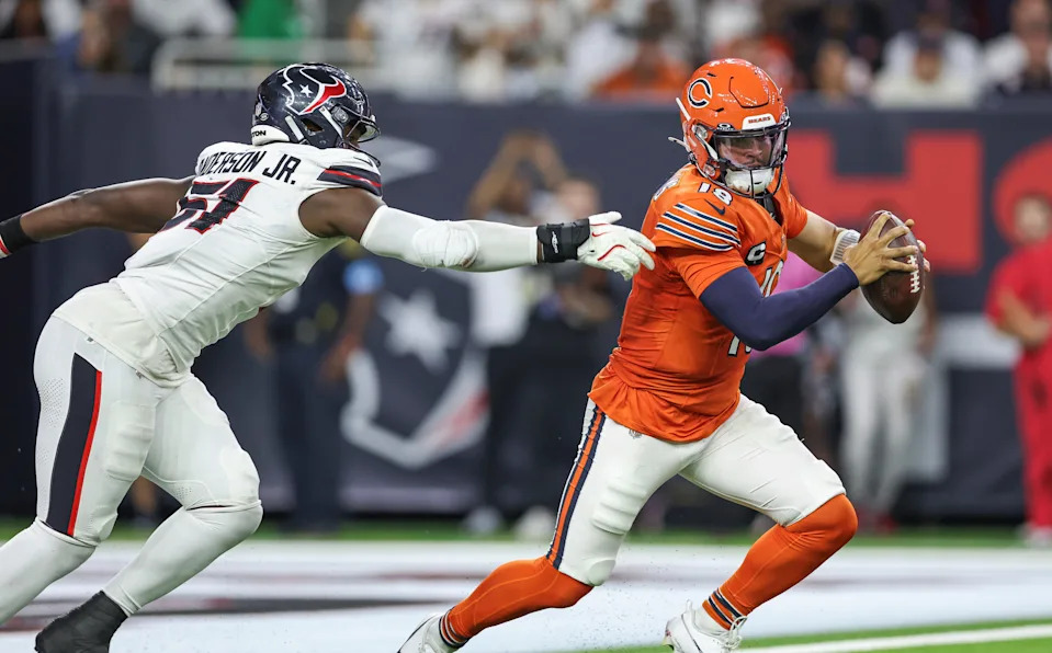 Sep 15, 2024; Houston, Texas, USA; Chicago Bears quarterback Caleb Williams (18) attempts to evade the tackle of Houston Texans defensive end Will Anderson Jr. (51) during the third quarter at NRG Stadium. Mandatory Credit: Troy Taormina-Imagn Images