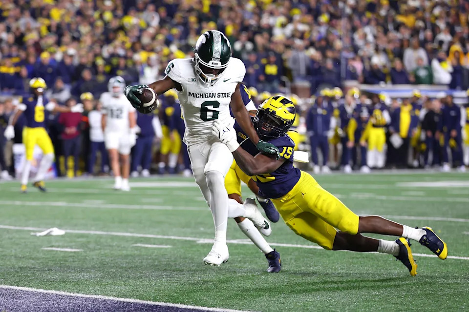 ANN ARBOR, MICHIGAN - OCTOBER 26: Nick Marsh #6 of the Michigan State Spartans catches a pass for a touchdown against Ernest Hausmann #15 of the Michigan Wolverines during the fourth quarter at Michigan Stadium on October 26, 2024 in Ann Arbor, Michigan. Michigan defeated Michigan State 24-17. (Photo by Gregory Shamus/Getty Images)