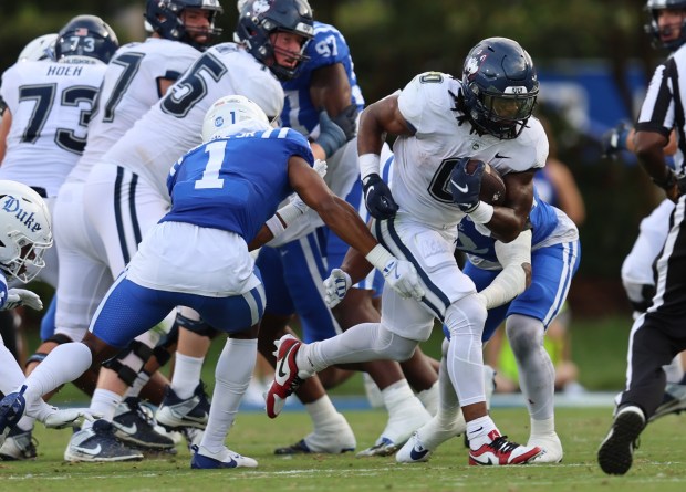 UConn runner Cam Edwards looks to evade the defense of Duke's Terry Moore (1) during the first half of the Huskies' game at the Blue Devils on Saturday night in Durham, NC. (Courtesy of UConn)