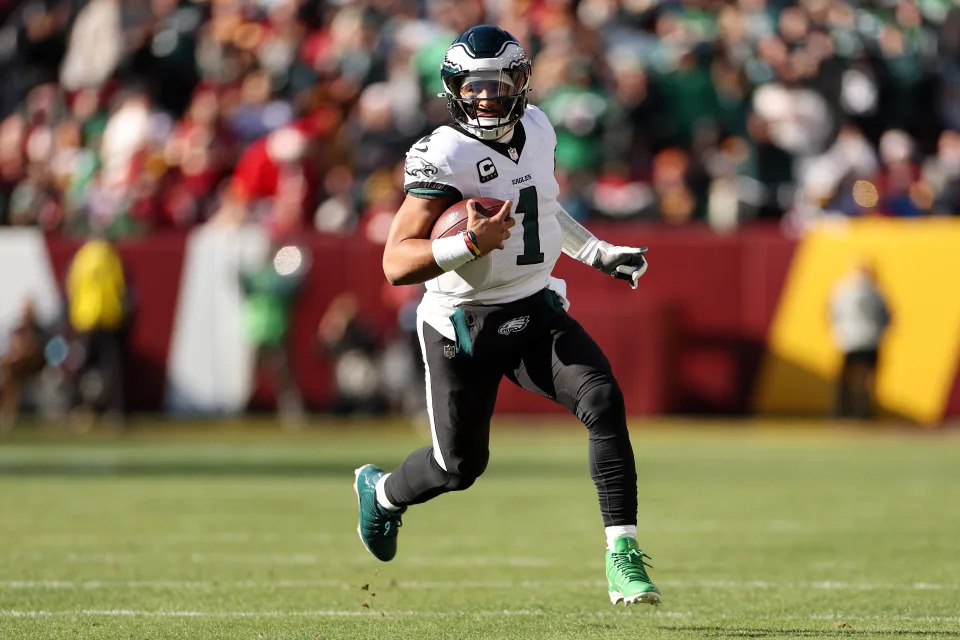 LANDOVER, MARYLAND - DECEMBER 22: Jalen Hurts #1 of the Philadelphia Eagles carries the ball against the Washington Commanders during the first quarter at Northwest Stadium on December 22, 2024 in Landover, Maryland. (Photo by Scott Taetsch/Getty Images)