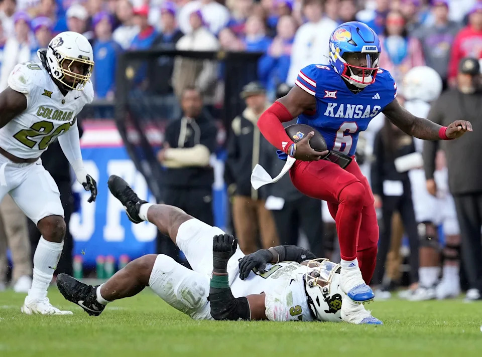 KANSAS CITY, MISSOURI - NOVEMBER 23: Quarterback Jalon Daniels #6 of the Kansas Jayhawks runs against defensive tackle Chidozie Nwankwo #97 of the Colorado Buffaloes in the first half at Arrowhead Stadium on November 23, 2024 in Kansas City, Missouri. (Photo by Ed Zurga/Getty Images)