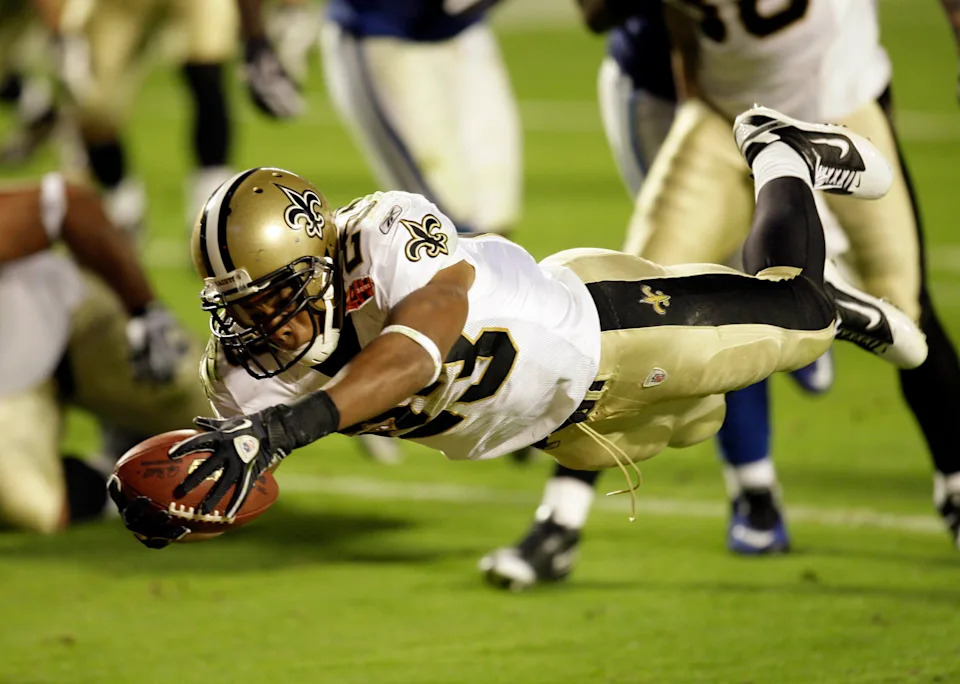Feb 7, 2010; Miami, FL, USA; New Orleans Saints running back Pierre Thomas (23) dives into the end zone for a touchdown during the third quarter of Super Bowl XLIV against the Indianapolis Colts at Sun Life Stadium. Mandatory Credit: Jeff Hanisch-USA TODAY Sports
