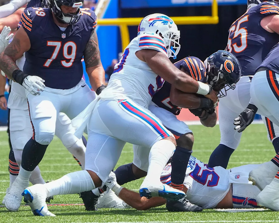 Aug 10, 2024; Orchard Park, New York, USA; Buffalo Bills defensive tackle DeWayne Carter (90) tackles Chicago Bears running back Khalil Herbert (24) during the first half at Highmark Stadium. Mandatory Credit: Gregory Fisher-USA TODAY Sports