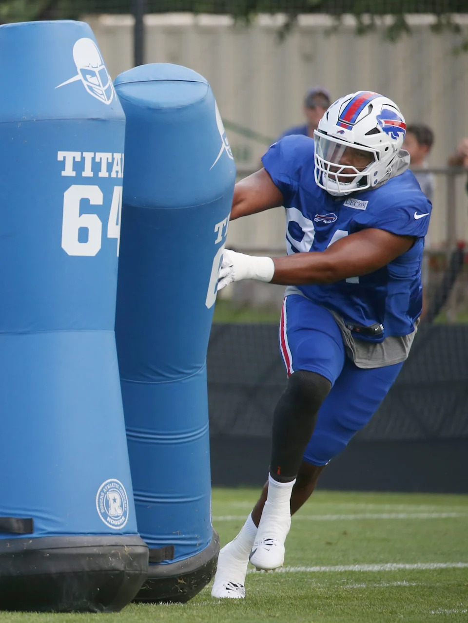 Bills edge Dawuane Smoot throws aside a blocking dummy as he works on defensive line drills.