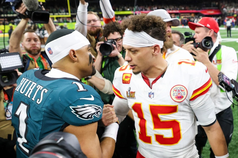 Jalen Hurts and Patrick Mahomes embracing after a football game.