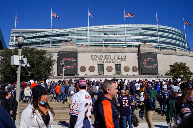 Fans walk outside the stadium before the Chicago Bears play...
